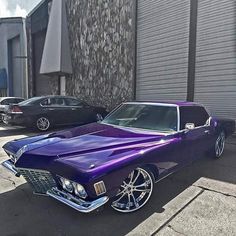 a purple car parked in front of a building