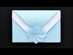 an origami envelope is folded in blue paper