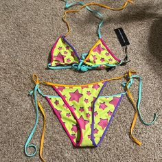 This Bikini Set Includes A Triangle Bra Top That Has A Stretchy Neoprene Construction, An All Over Star Print, Slight Ruching, Contrast Colored Tie Closures, Matching Bikini Bottoms And A Sheer Mesh Sarong. Sarong Is A More Muted Color Than The Swimsuit Early 2000s Swimsuit, Scene Swimwear, 2000s Bikinis, Ed Hardy Bathing Suits, Deadpool Outfit, Mcbling Swimsuit, Cutesy Outfits, Cutesy Outfit, Hippie Car