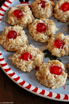 cookies with cherries are arranged on a plate