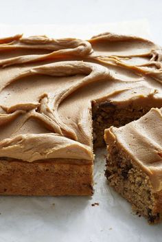 a cake that has been cut into pieces and is sitting on a piece of parchment paper