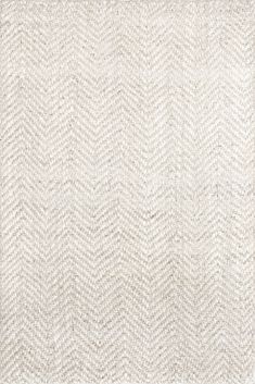 an area rug with white and gray herringbones