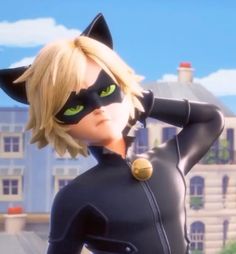 the animated character is dressed in black cat suit with green eyes and yellow hair, standing next to a large building