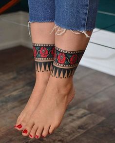 a woman's legs with tattoos on them