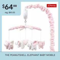 a pink baby mobile with elephants hanging from it's side and the price is $ 64 00