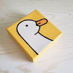 a yellow box with a white bird on it's face and an orange nose