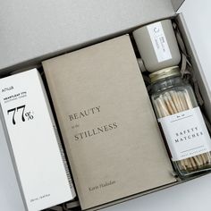 an open box containing matches, candles and a book with the words beauty in it