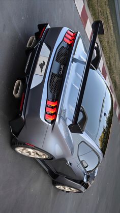 the rear end of a silver sports car