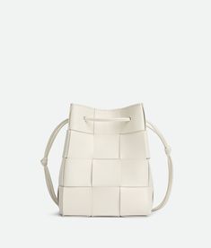 The Bottega Veneta Small Crossbody Bucket Bag combines contemporary style with practicality. Crafted with meticulous attention to detail, this bag features a sleek silhouette that's both modern and timeless. The compact size makes it perfect for carrying essentials, while the crossbody strap ensures hands-free convenience. With its versatile design and luxurious craftsmanship, the Bottega Veneta Small Crossbody Bucket Bag effortlessly elevates any ensemble, whether for daily errands or special occasions. Perfect for the fashion-forward individual seeking both style and functionality, this bag is a statement accessory that exudes understated elegance. Bottega Veneta Cassette, Small Buckets, Accessories Gold, Small Crosses, Metal Accessories, Small Crossbody, Color Code, Lambskin Leather, Luxury Items