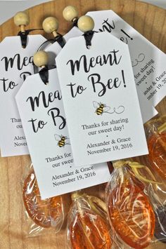 three tags that say meant to bee on top of some lollipop candies