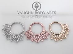 three pairs of rose gold, silver and bronze hoop earrings with leaves on each side