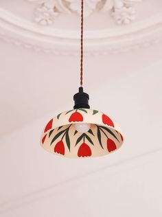 a red and white light hanging from a ceiling