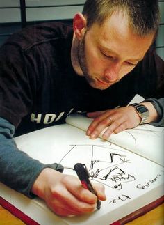 a man is signing something on a book