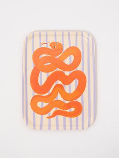 an orange snake on a blue and white striped plate