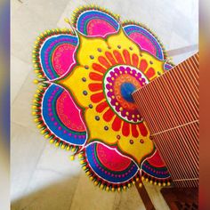 an intricately designed rangoli design on the floor