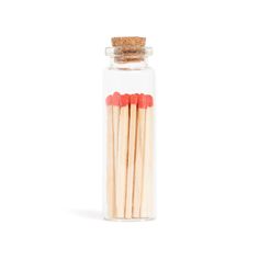 several matches in a glass jar on a white background