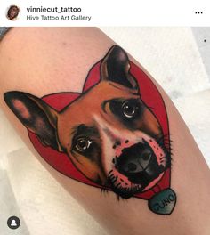 a dog with a heart tattoo on it's leg