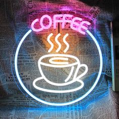 a neon sign with a coffee cup on it