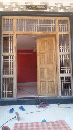 an open wooden door on the side of a building