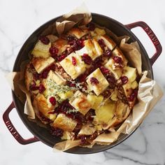 a pan filled with bread and cranberry sauce on top of a marble counter