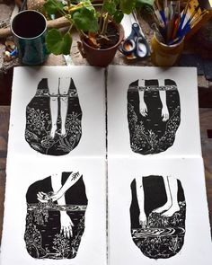 three black and white prints on top of a wooden table next to potted plants