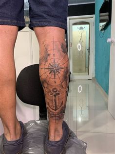 a man with a compass tattoo on his leg