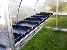 the inside of a greenhouse with grass growing in it