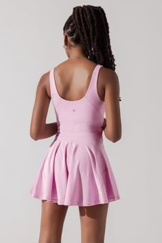 From dancing to hiking to tennis to running, to running to Trader Joe’s... this all-in-one dress is one of our most versatile pieces we’ve ever designed. Compression Level: Performance Level: Pink Athletic Dress, Cute Tennis Dress, Lululemon Tennis Outfit, Tennis Dress Aesthetic, Tennis Dress Outfit Fashion, Netball Outfit, Blogilates Clothes, Athletic Dress Outfit, Netball Outfits