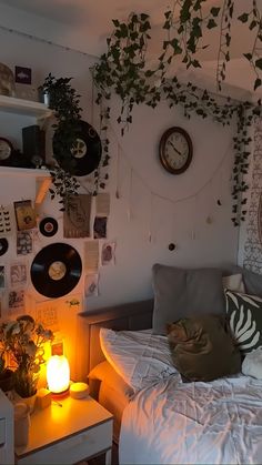 a bedroom with plants and records on the wall