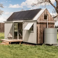 a small house with a metal tub next to it