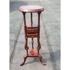 an old wooden table with a drawer on it