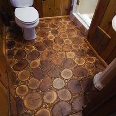 a bathroom with wood flooring and wooden cabinets