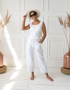 Step into summer with our White Linen Tank Top and Pants Set, the epitome of breezy elegance. This women's co-ord set is handcrafted with care from the softest natural linen, designed to keep you cool and comfortable on the warmest days. PRODUCT FEATURES: - Expertly handcrafted, celebrating the art of traditional tailoring. - Constructed from 100% premium, soft natural linen, ensuring optimal breathability and comfort. - The sleeveless tank top offers a relaxed fit, perfect for laid-back summer White Linen Summer Sets, White Linen Casual Sets, White Linen Sets For Spring, Chic White Linen Sets, Chic White Relaxed Fit Sets, Summer Linen Loungewear Set, Chic Linen Sets For Beach, Chic Linen Beach Sets, Summer Linen Sets With Relaxed Fit