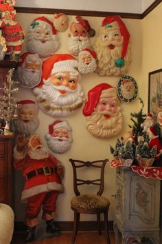 christmas decorations are hanging on the wall next to a chair