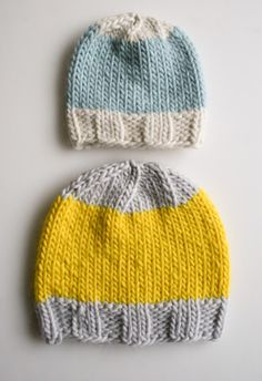 two knitted hats sitting next to each other