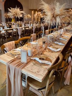 the tables are set with place settings and centerpieces for an elegant dinner party