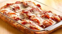 a glass casserole dish filled with meat and cheese