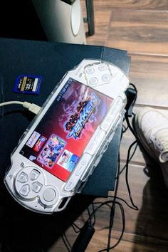 a nintendo wii game system sitting on top of a table next to a pair of shoes