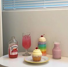 cupcakes and drinks are sitting on a table