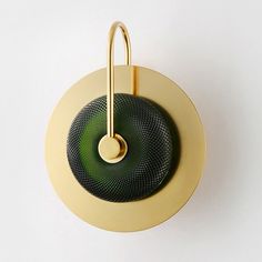 a green and yellow object hanging from a hook