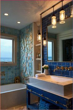 a bathroom with blue and white tiles on the walls, sink and bathtub in it