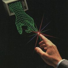 a hand is pointing at an object with green light