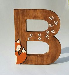 the letter b is made up of wood and has a fox on it