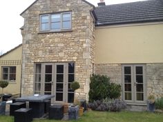 an outside view of a house with stone walls and windows