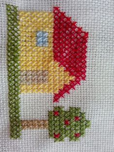 a cross stitch pattern with a red and yellow flower