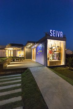 a house made out of shipping containers with the word seiva written on it's side