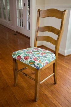 a wooden chair sitting on top of a hard wood floor next to a door way