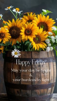 a wooden barrel filled with sunflowers and daisies