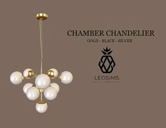 a chandelier with white balls hanging from it's center and gold accents