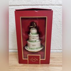 a christmas ornament in a red box with a white cake on it's side